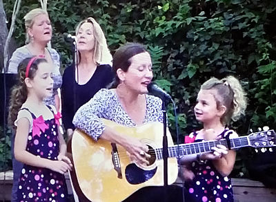 Kathleen singing with her mother, sister, and daughters Lola and Chloe Salsbury Lipson at a concert in San Luis Obispo